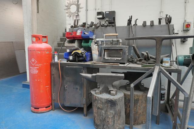 Werkplaats voor metaal met aambeelden en gereedschap